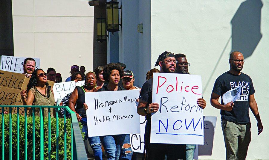 Students protesting around the Starbucks at the student union holding signs about their concerns.