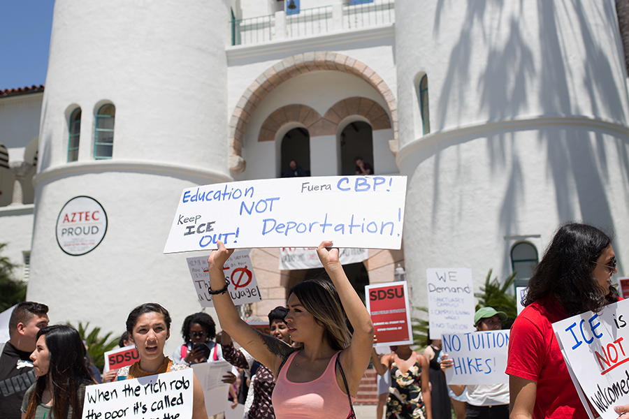 A sign from the May Day march on campus expresses student frustrations over uncertain immigration policies under President Trump.