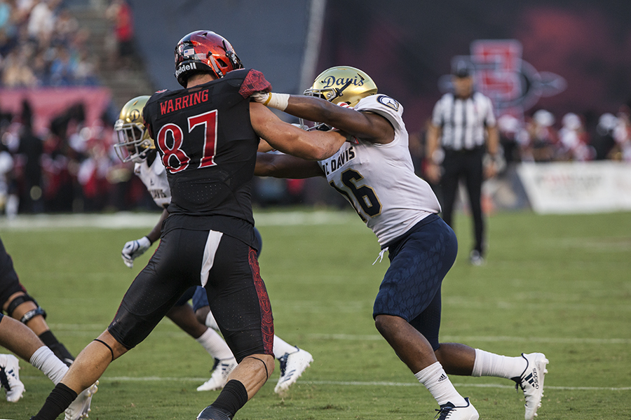 Sophomore tight end Kahale Warring blocks a UC Davis player during SDSUs 38-17 win.
