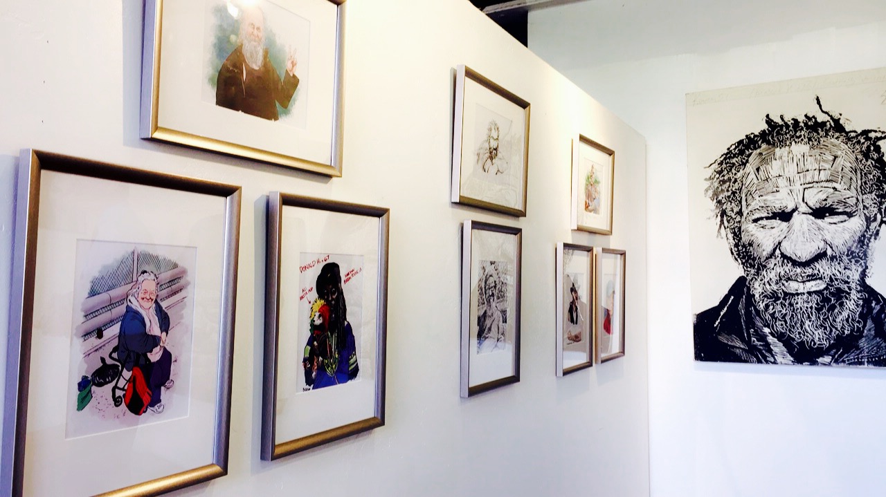The work of Pulitzer-Prize winning Union Tribune cartoonist Steve Breen is displayed alongside the work of artist and SDSU professor Neil Shigley at “The Art of Ending Homelessness” event in North Park.