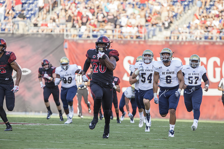 Senior running back Rashaad Penny outruns a slew of UC Davis defenders during SDSUs 38-17 win.