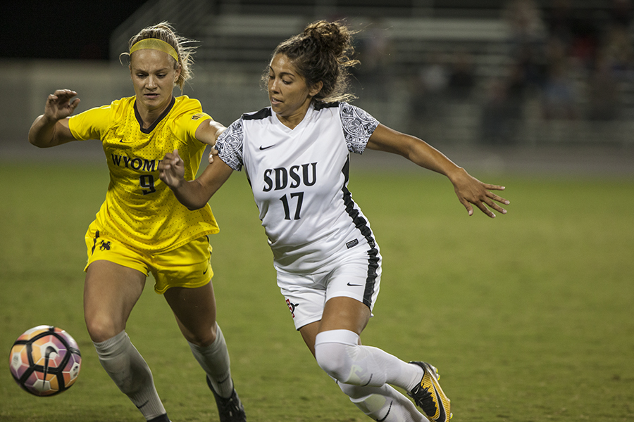 Senior forward Aaliyah Utush wrestles with Wyoming junior defender Alyssa Murray during SDSU's 2-1 win over the Cowgirls.