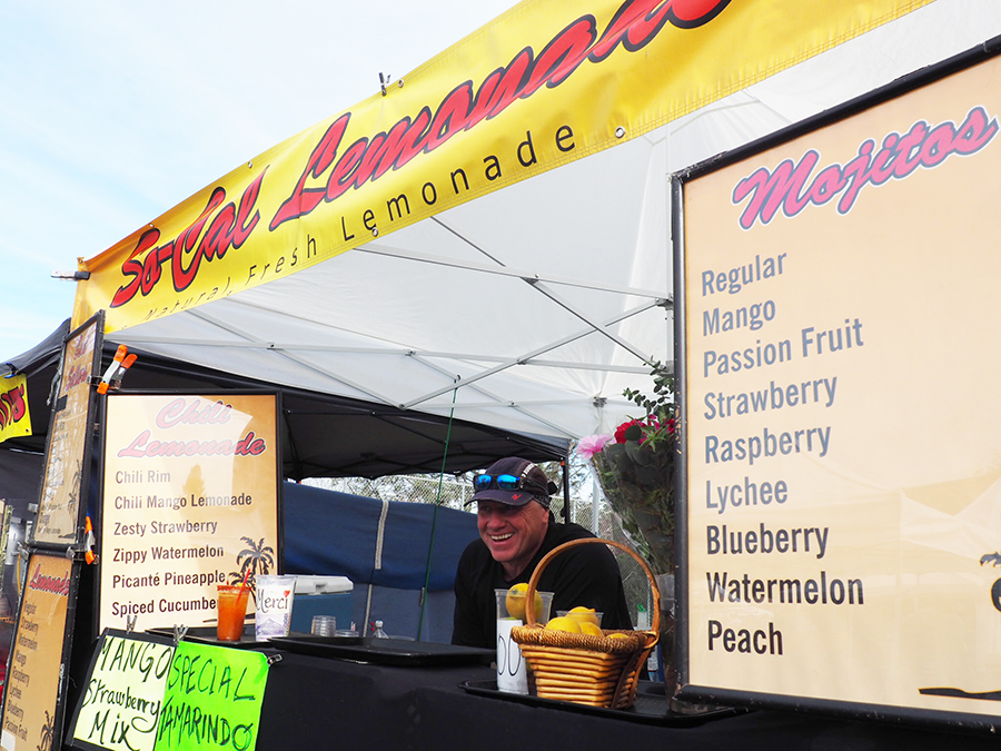 Monsieur Jean-Michel smiles at his lemonade stand at the La Jolla farmer’s market Dec. 10.