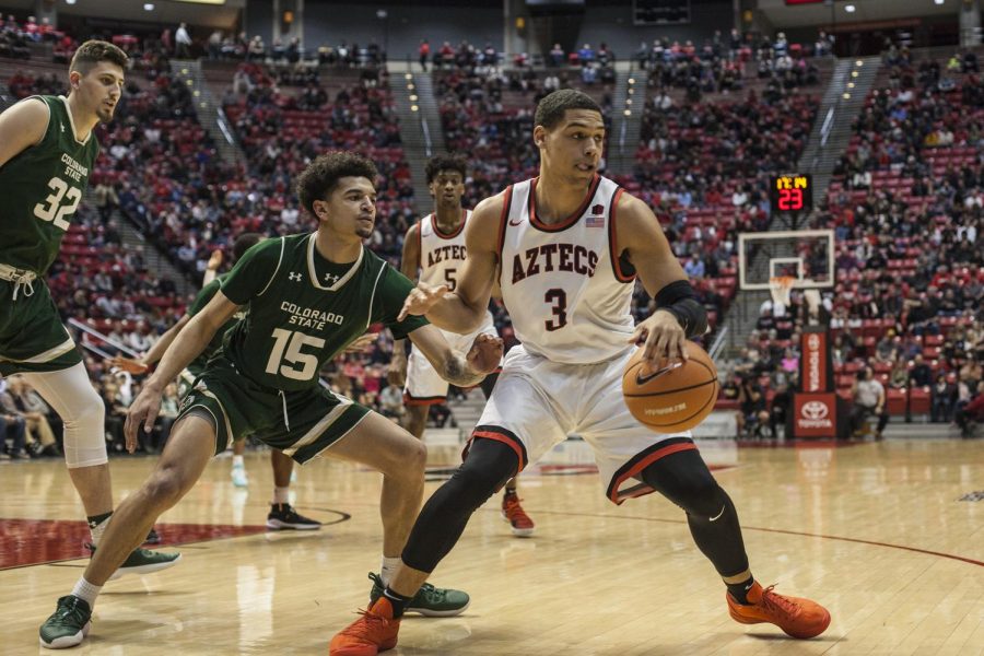 Senior guard Trey Kell (3) dribbles the ball against Colorado State redshirt sophomore guard Anthony Bonner during the Aztecs 97-78 victory over the Rams at Viejas Arena on Jan. 24