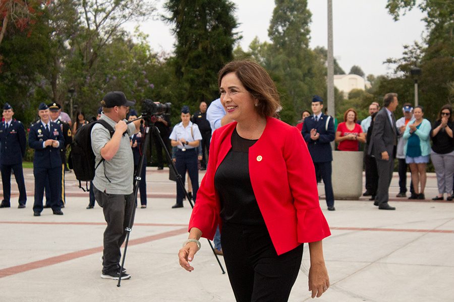San Diego State President Adela de la Torre walks toward guests after a flag raising ceremony in June 2018.
