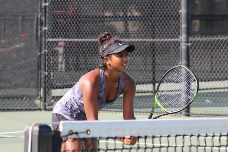 Freshman Aesha Patel readies for a service during a doubles match against UTEP on Sept. 30 at the Aztec Tennis Center.