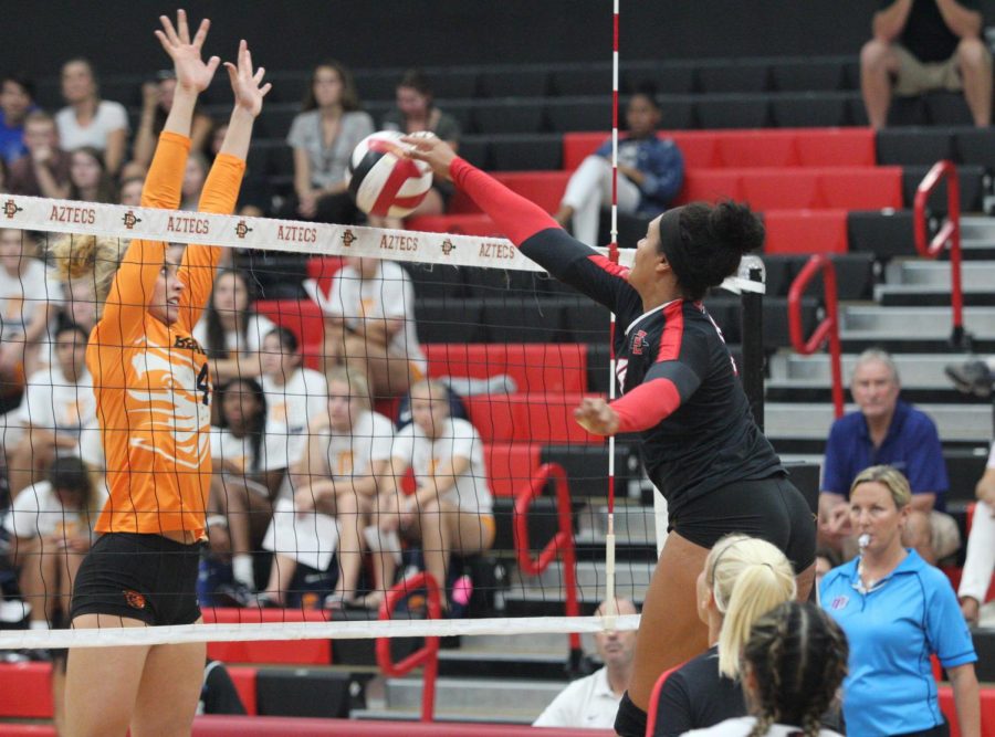 Senior middle blocker Deja Harris spikes the ball during the Aztecs four-set loss to Oregon State on Sept. 14 at Peterson Gym. 