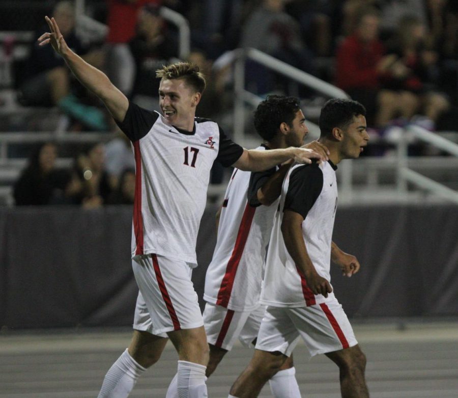 Redshirt-freshman midfielder Reagan Sherlock (left) celebrates with junior midfielder Spencer Madden (middle) and senior forward Damian German (right) during the Aztecs 2-0 victory over Brown on Sept. 15 at the SDSU Sports Deck. German had two goals during the match. 