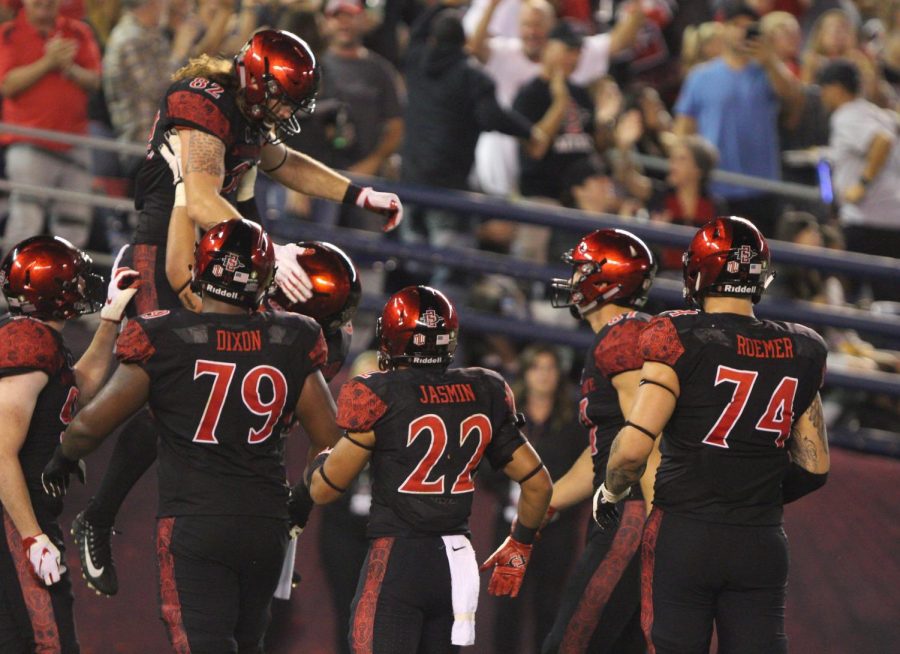 Junior tight end Parker Houston is lifted up in the end zone by his teammates after catching a second quarter touchdown during the Aztecs 23-20 victory over Eastern Michigan on Sept. 22 at SDCCU Stadium. 