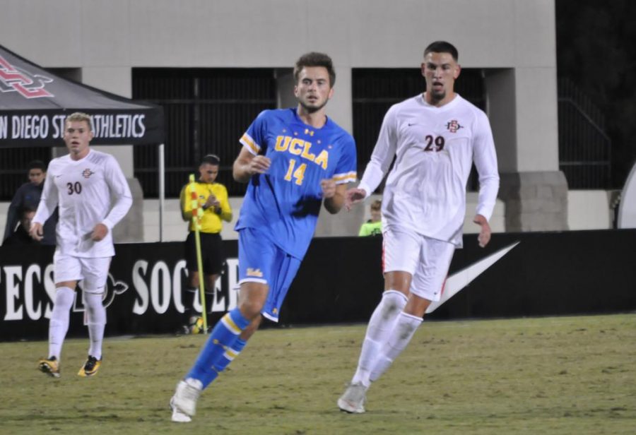 SDSU junior midfielder AJ Valenzuela and UCLA sophomore defender Eric Iloski chase down the ball during UCLAs 2-1 victory over the Aztecs on Oct. 13 at the SDSU Sports Deck.
