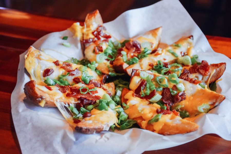 Potato+skins%2C+with+generous+toppings+of+cheese%2C+bacon+and+green+onions%2C+are+a+great+game+day+or+late+night+snack.
