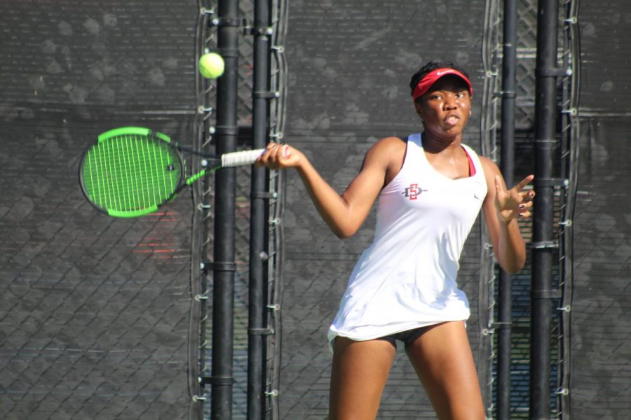 Sophomore Nnena Nadozie competes in her doubles match during the Aztecs 7-0 victory over UC Riverside on Jan. 27 at the Aztec Tennis Center.