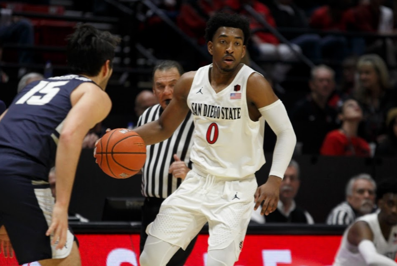 Senior guard Devin Watson carries the ball during the Aztecs 68-63 victory over Utah State on Feb. 9 at Viejas Arena. Watson finished with a team-high 23 points for SDSU. 