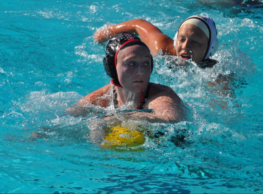 Then-sophomore utility Emily Bennett keeps the ball away from a Santa Clara defender during the Aztecs 4-1 victory over the Broncos on March 28, 2019 at the Aztec Aquaplex.