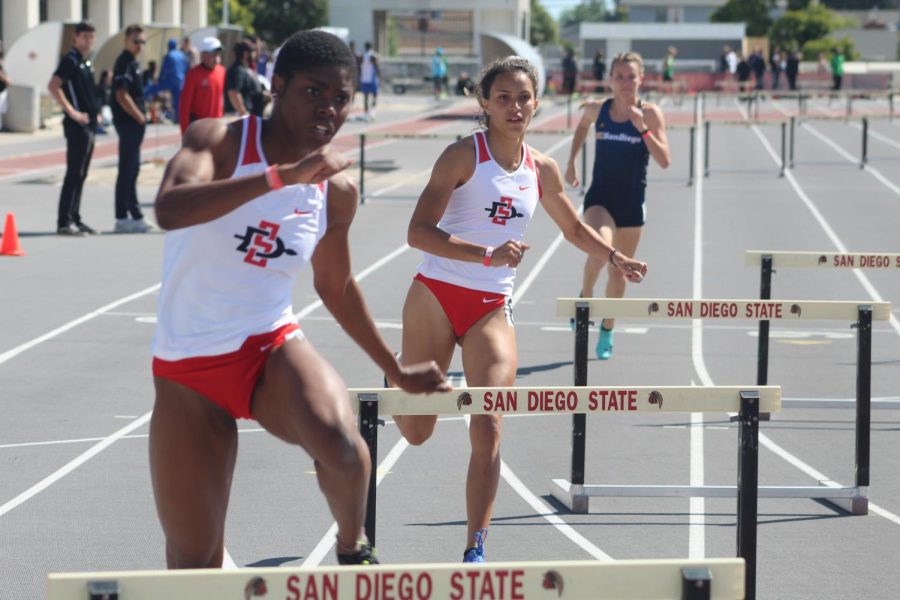 Freshman hurdler Nia Collins (front left) and sophomore hurdler Mia Brosch (middle) compete in the 400 meter hurdles during the Aztec Open & Invitational on March 23 at the Aztrack Sports Deck.