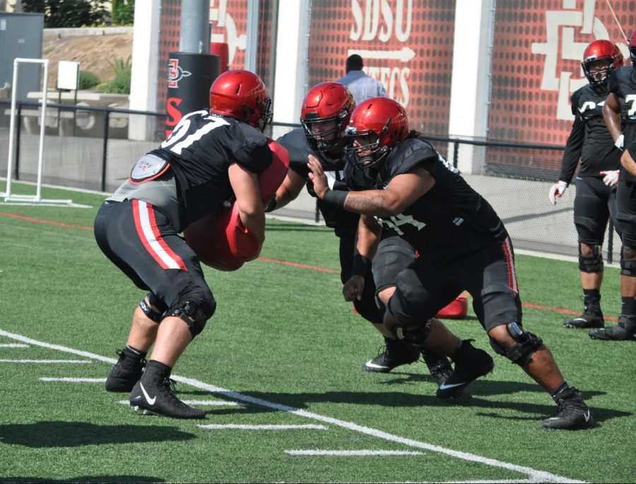 San Diego State offensive linemen work on a drill during a fall camp practice on Aug. 7 at SDSU Practice Field.