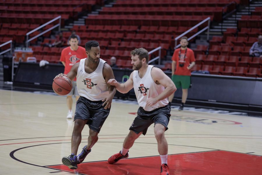 Two campers competing against each other during a five-on-five match at the second annual Aztec Fantasy Camp on Sept. 28 at Viejas Arena.