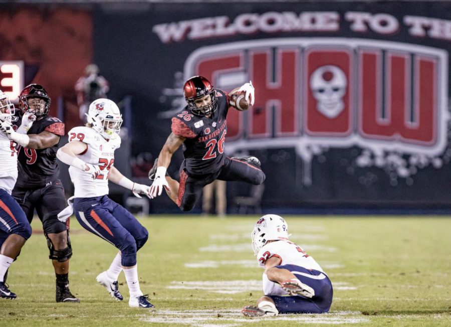 Sophomore running back Kaegun Williams attempts to go airborne for the first down during the Aztecs 17-7 victory over Fresno State on Nov. 15 at SDCCU Stadium.