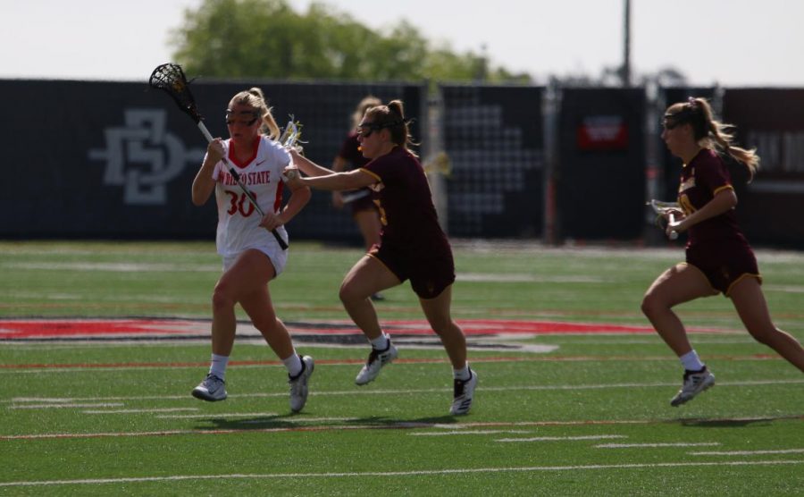Junior midfielder Bailey Brown attempts to run the ball upfield during the Aztecs 19-18 win over Arizona State on Feb. 20 at Aztec Lacrosse Field.