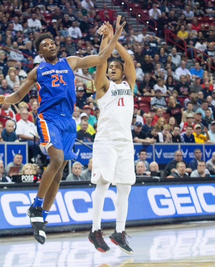 Aztecs junior forward Matt Mitchell fires a 3-pointer over a Boise State defender during a 81-68 SDSU win on March 6 at the Thomas and Mack Center in Las Vegas.