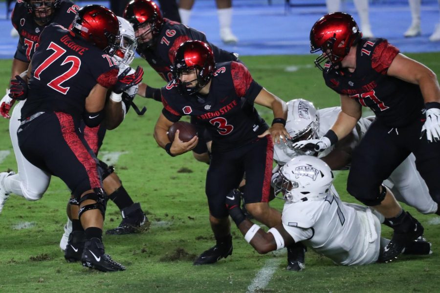 Sophomore quarterback Carson Baker attempts to escape a defender during the Aztecs 34-6 win over UNLV on Oct. 24 at Dignity Health Sports Park in Carson, Calif.