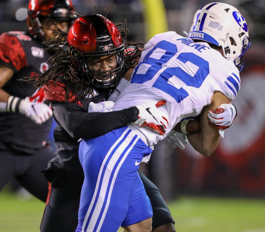 Then-junior safety Dwayne Johnson Jr. lays a hit on a BYU receiver during the Aztecs’ 13-3 victory on Nov. 30, 2019 at SDCCU Stadium. With the help of former SDSU cornerback Ron Smith and his sister, Johnson Jr. started a GoFundMe page called the Building Connections Project Fund, assisting low-income families with online learning resources.