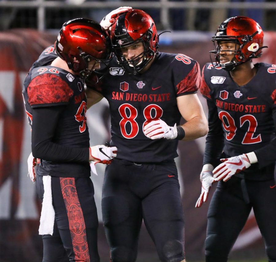 Then-sophomore tight end Daniel Bellinger (88) celebrates with then-sophomore wide reciever Elijah Kothe after Bellinger caught a touchdown pass during the Aztecs’ 13-3 victory over Brigham Young on Nov. 30, 2019 at SDCCU Stadium.