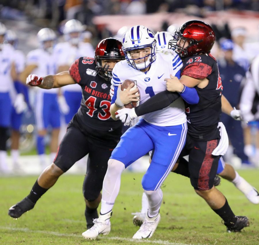 Brigham Young then-sophomore quarterback Zach Wilson is sacked by San Diego State then-senior linebacker Troy Cassidy (right) and then-sophomore linebacker Seyddrick Lakalaka during the Aztecs 13-3 win over the Cougars on Nov. 30, 2019 at SDCCU Stadium.