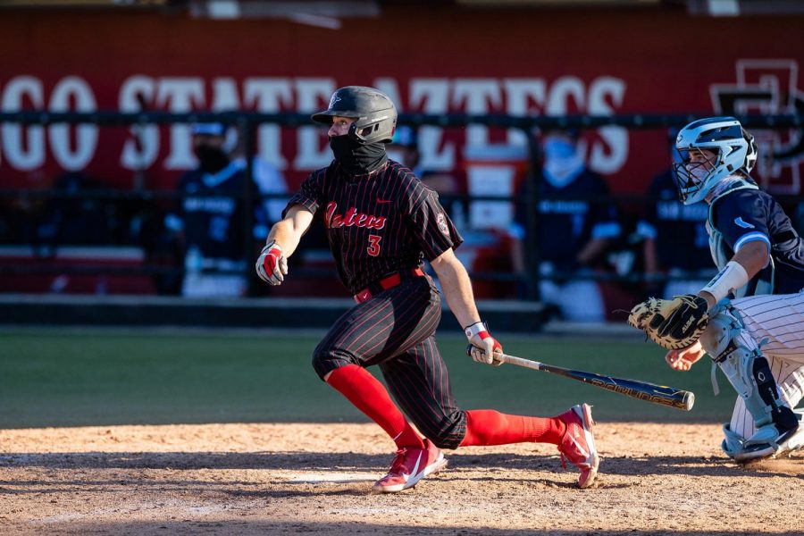 San Diego State baseball redshirt sophomore catcher Wyatt Hendrie finishes his follow-through on a swing during the Aztecs series against San Diego on Feb. 19-21, 2021.