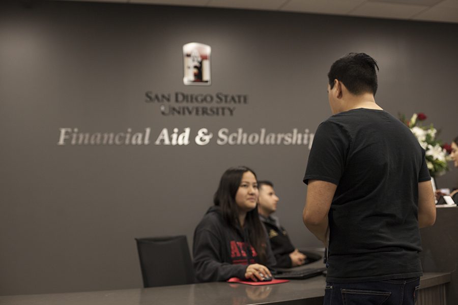 A student talks to a representative at the San Diego State office of Financial Aid and scholarships