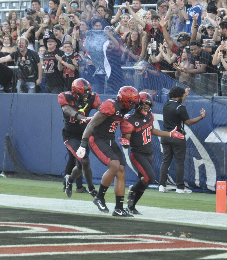 Running Back Jordyn Byrd (right) celebrates with his teammates after scoring a touchdown against Utah