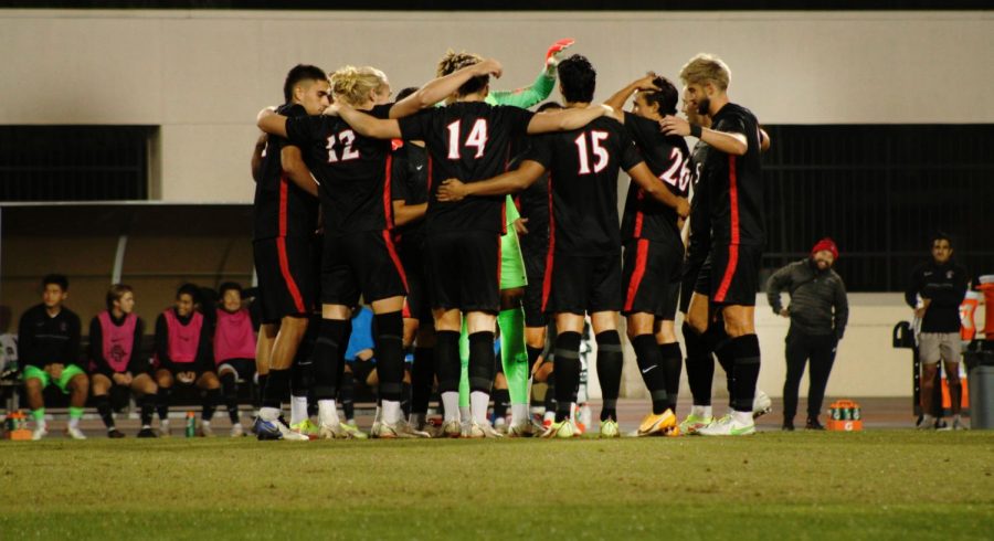 The San Diego State men's soccer team huddle up during a match against Oregon State.