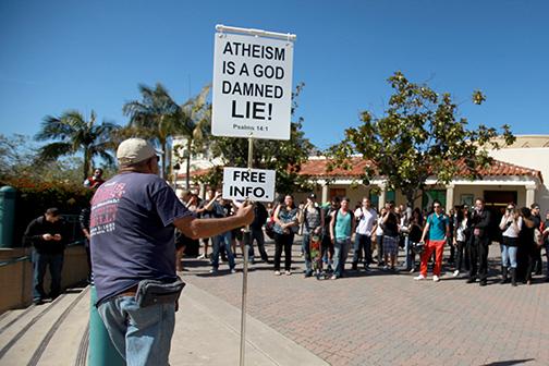 A religious protestor stands in front of East Commons last spring.