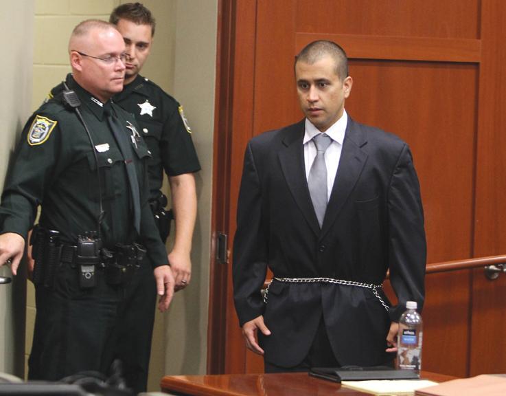Zimmerman appearing before Circuit Judge Kenneth Lester in a suit and handcuffs, flanked by Florida police officers. MCT Campus