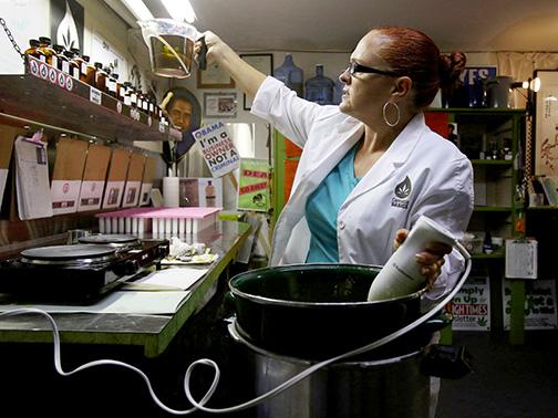 Aimee "Ah" Warner, CEO and founder of Cannabis Basics, cooks up a batch of topical medications for pain relief, all legal, September 20, 2013, in Seattle. She has convened a group called Women of Weed because the marijuana industry and movement have long been male dominated. (Alan Berner/Seattle Times/MCT)