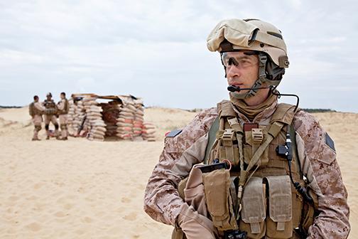 American soldier stands in the sun