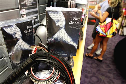 A couple browses adult toys near the "50 Shades of Grey" trilogy area at the Hustler Hollywood, July 30, 2012, in South Florida. Hustler and other erotica shops have seen an increase in sales of items talked about in the book. Also, the customers coming in aren't the "regulars" but shy people looking to venture into a new territory. ()