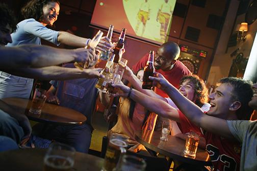 Soccer Fans and Young Adults Make a Toast in Bar