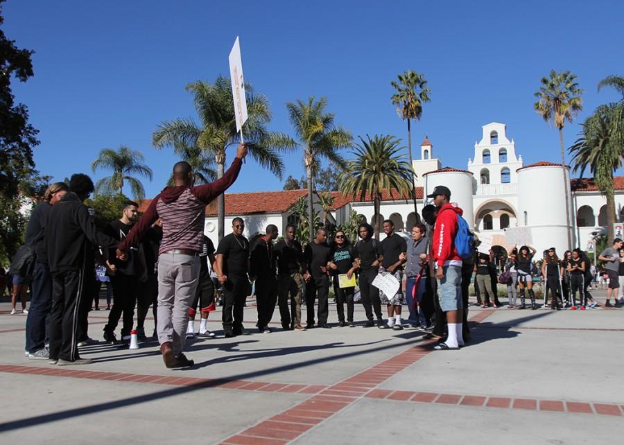 Males participating in the protest were invited to the center of the circle as the group chanted their support.