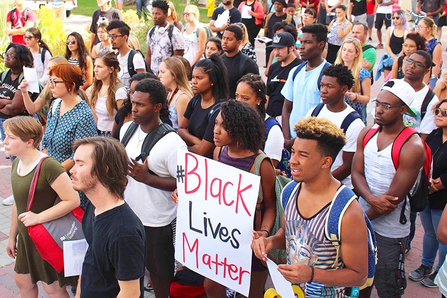 Protesters holding a sign about Back Lives Matter