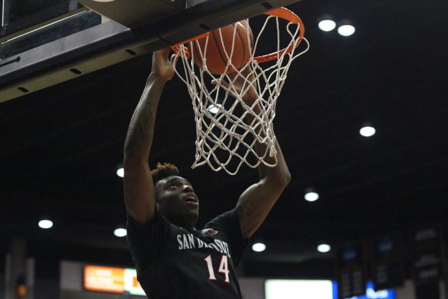 Redshirt sophomore forward Zylan Cheatham finishes a dunk in the Aztecs' 46-28 win over San Diego Christian.
