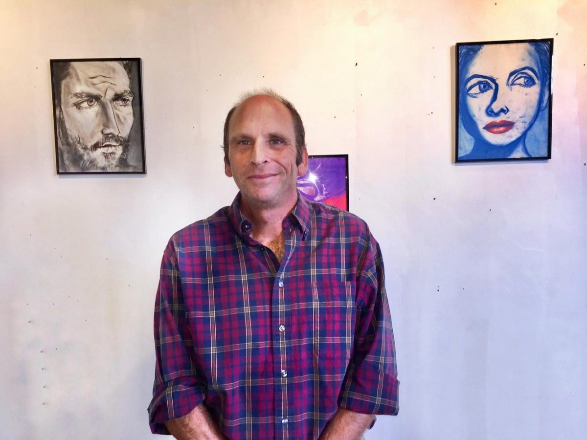 Allan Ostermann shows off his expressionist creations at “The Art of Ending Homelessness” event held at the Digital Gym in North Park Sept. 20. 