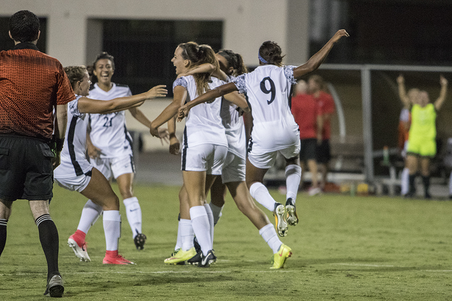 Senior midfielder Angela Mitchell celebrates with several other SDSU players after a goal over USD.