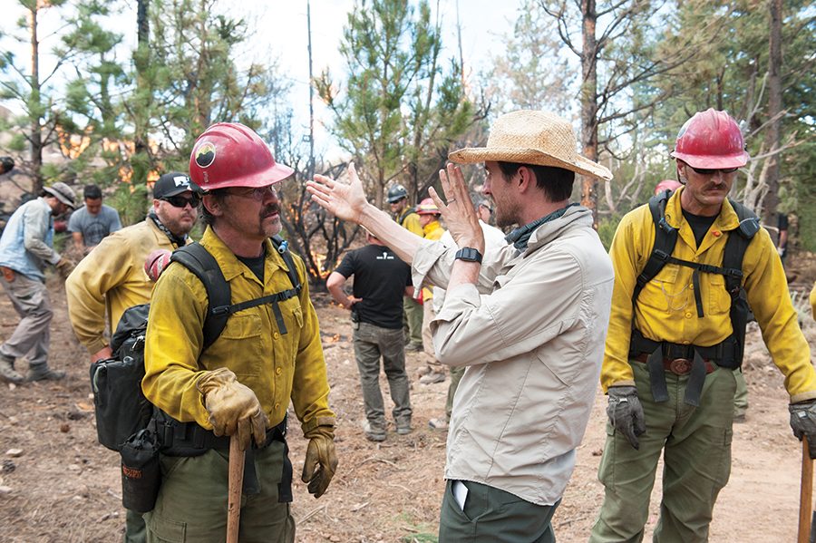 Director Joseph Kosinski speaks with actor Josh Brolin while on the set of Columbia Pictures Only the Brave.