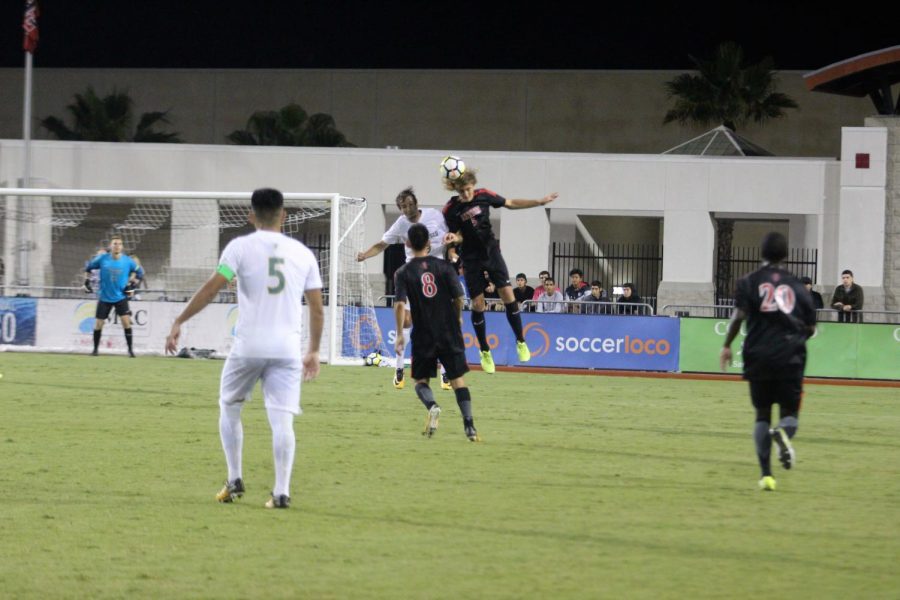 Junior defender Kyle Adams  competes for a header against the University of San Francisco on Sept. 8. The Aztecs lost the match 2-1. 