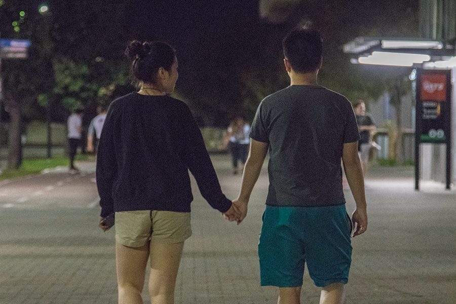 Sylvia+Zhou+and+Tim+Xu+hold+hands+outside+San+Diego+State+trolley+station.