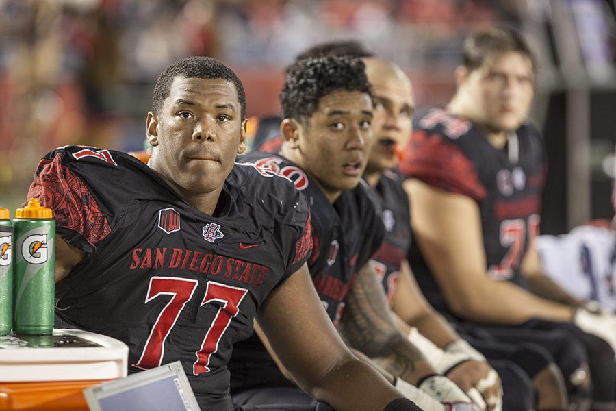 Junior+offensive+lineman+Ryan+Pope+%2877%29+and+redshirt+freshman+Keith+Ismael+%2860%29+look+on+from+the+bench+during+the+Aztecs+27-3+loss+to+Fresno+State.