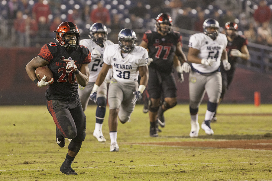 Senior running back Rashaad Penny runs ahead of the Nevada defense during SDSU's 42-23 win over the Wolf Pack on Nov. 18.