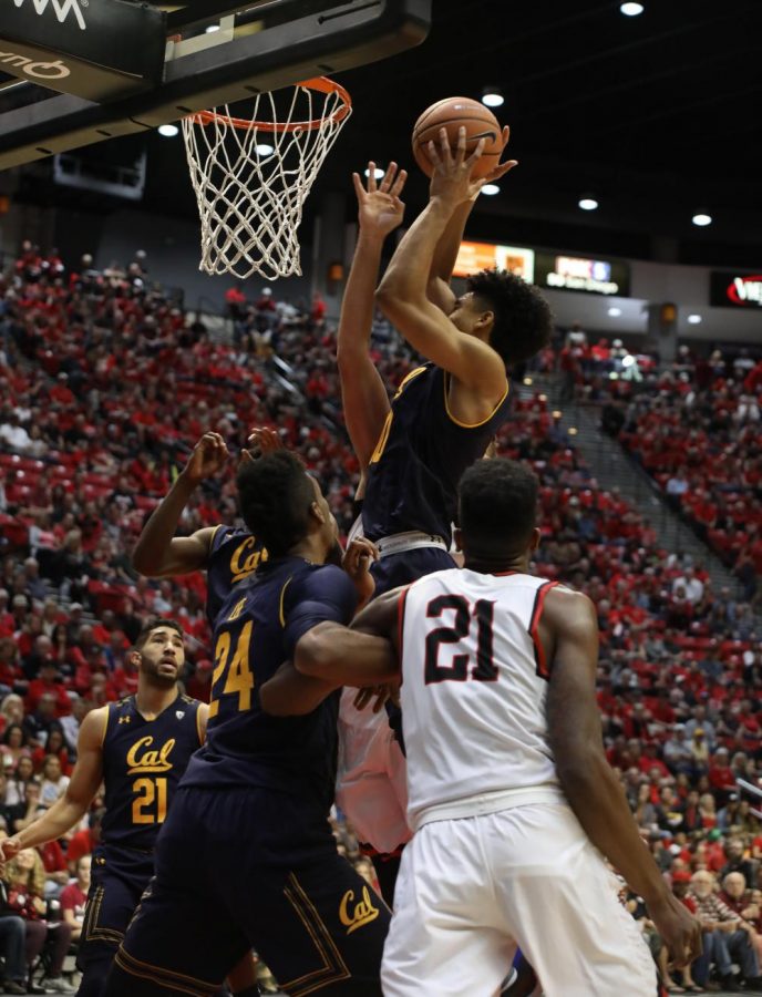 Malik Pope (21) looks on as Cal freshman forward Justice Sueing attempts a shot in the Aztecs 63-62 loss at Viejas Arena on Dec. 9