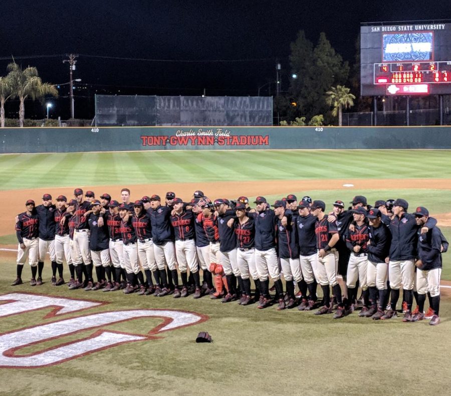 Aztecs players sing the fight song after defeating Michigan 4-3 on Feb. 26 at Tony Gwynn Stadium. 